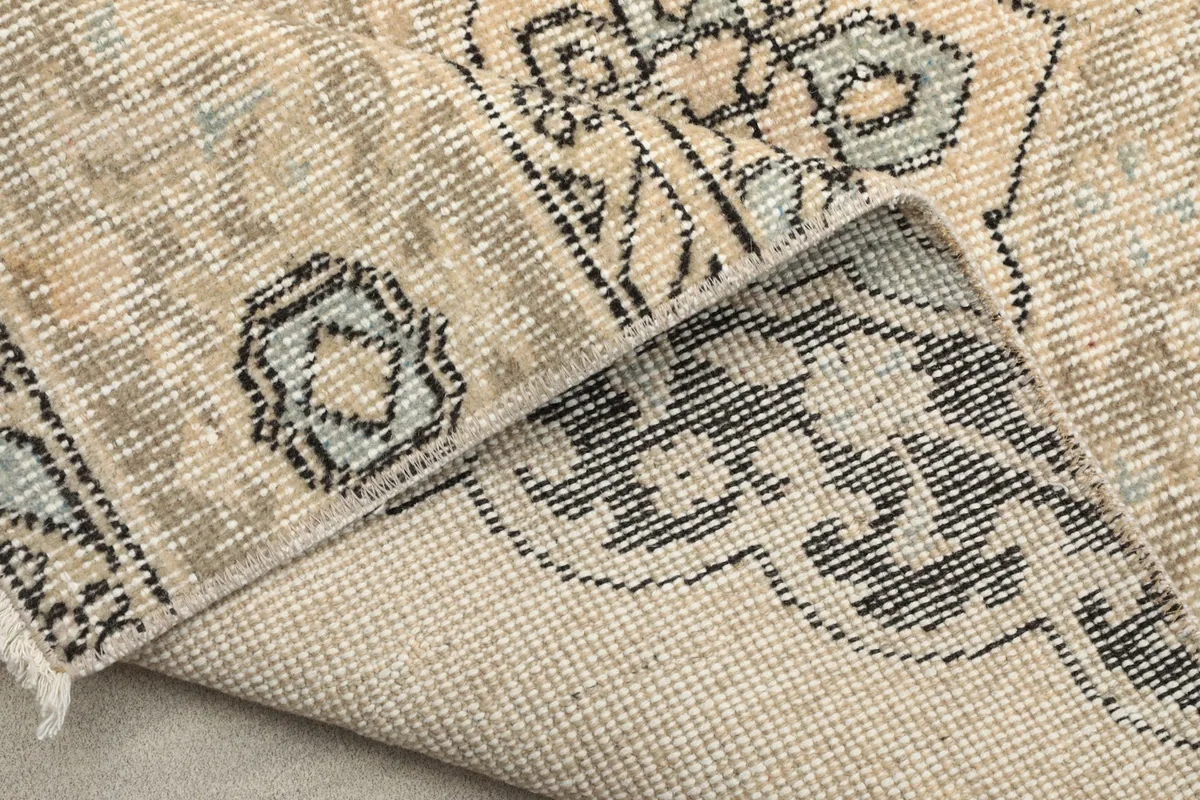 Underside of the runner rug, showing the consistent knotting and cotton foundation