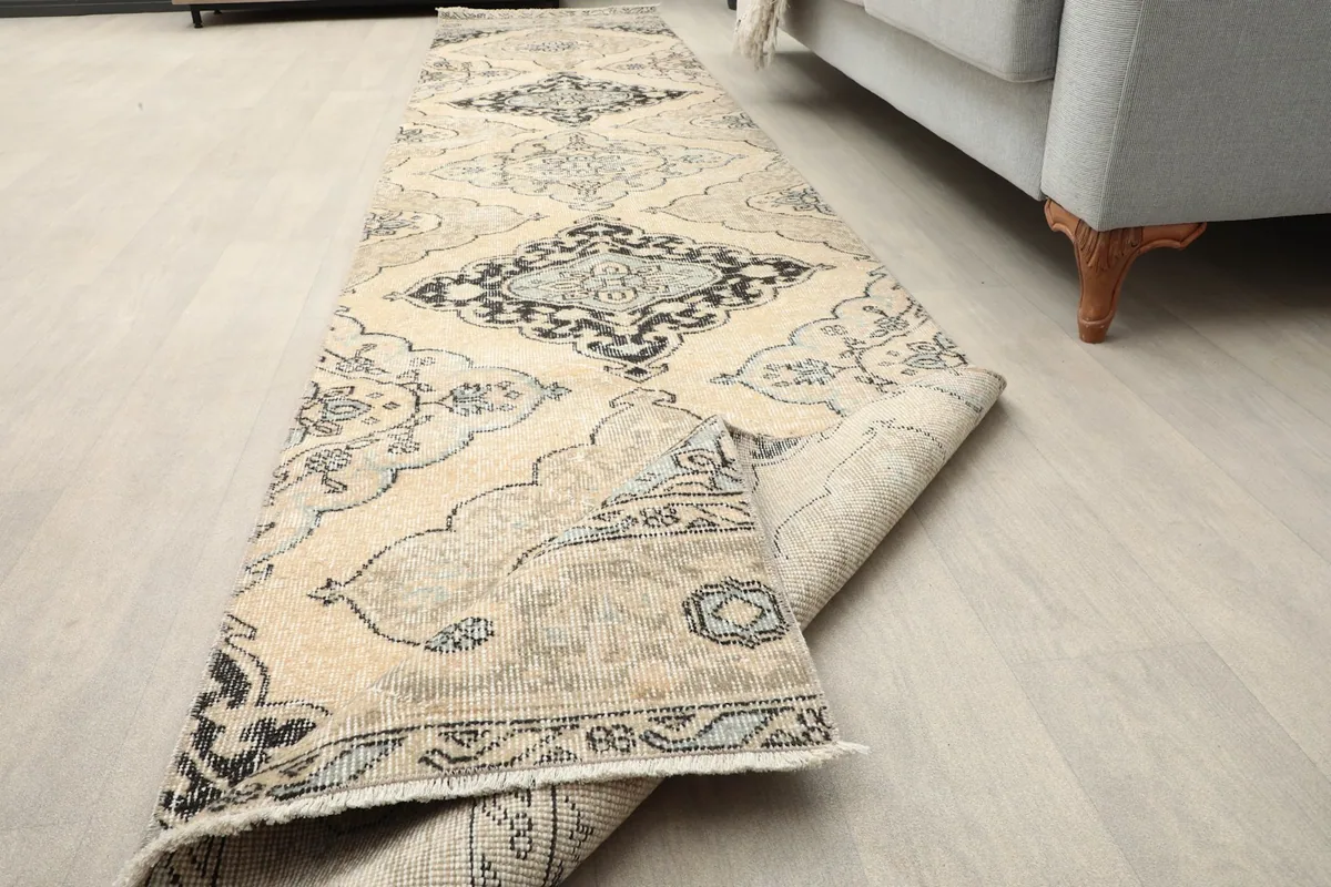 Partially rolled rug in a room setting, demonstrating its flexibility and lay