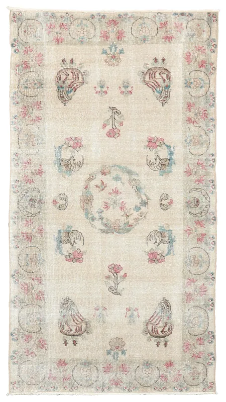 Full top view of the 3'7" x 6'9" beige vintage Anatolian rug with rose and blue floral patterns on a white background.