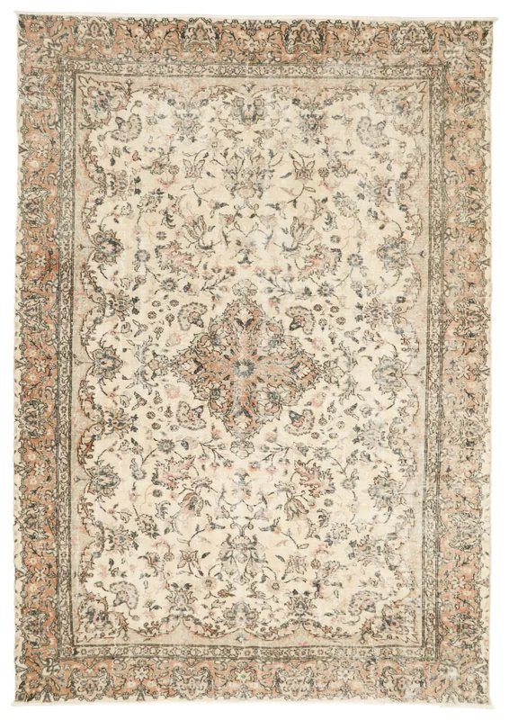 Full overhead view of the vintage ivory and rust floral medallion area rug