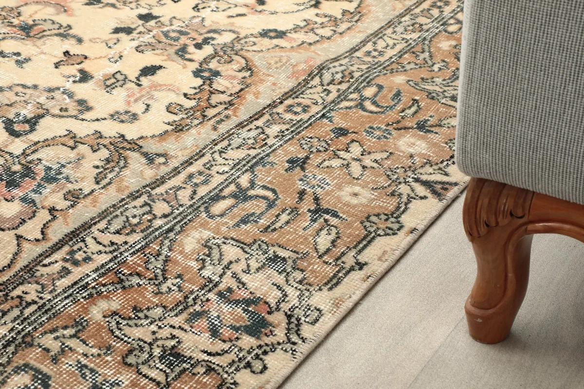 Close-up of the rug's border next to furniture, showing its integration in a room