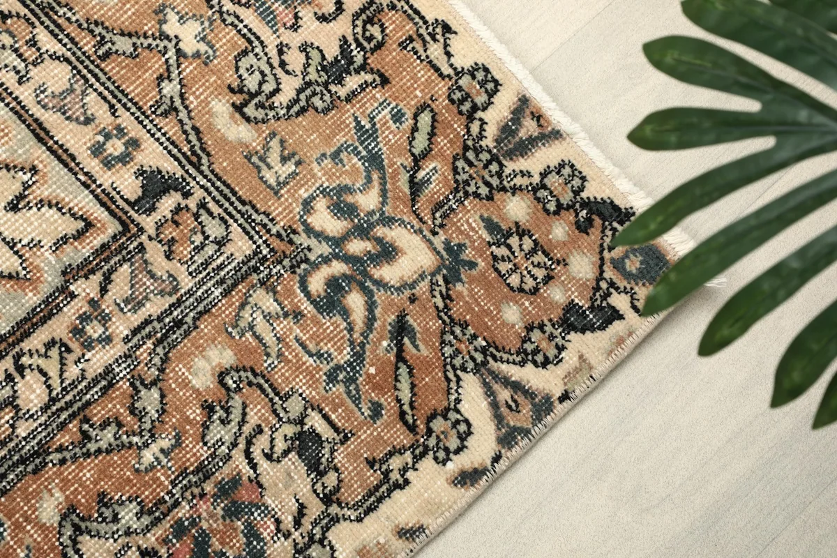 Close-up of the rug's border and field patterns with blue and black accents