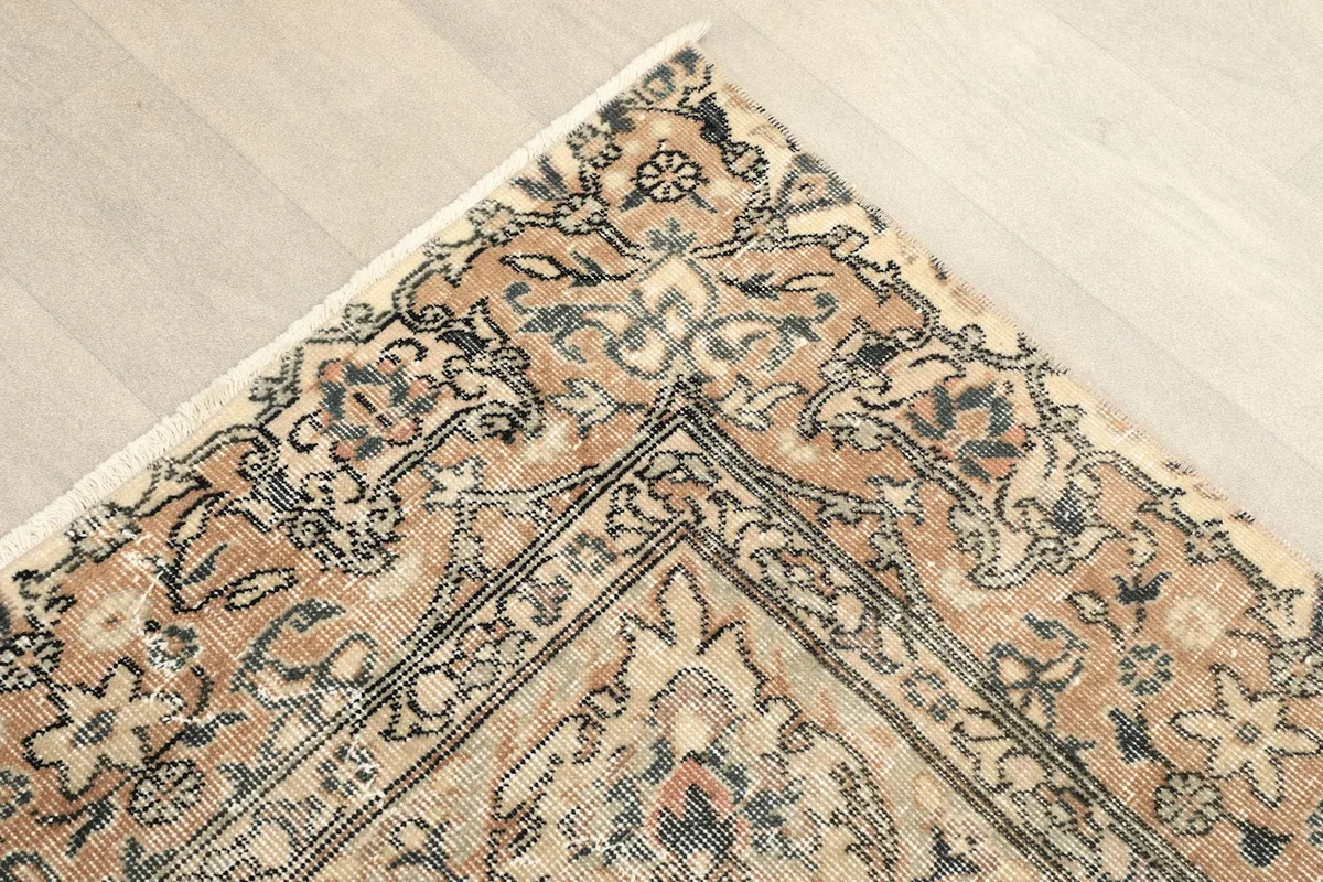Corner detail of the rug showing the intricate border design and colors