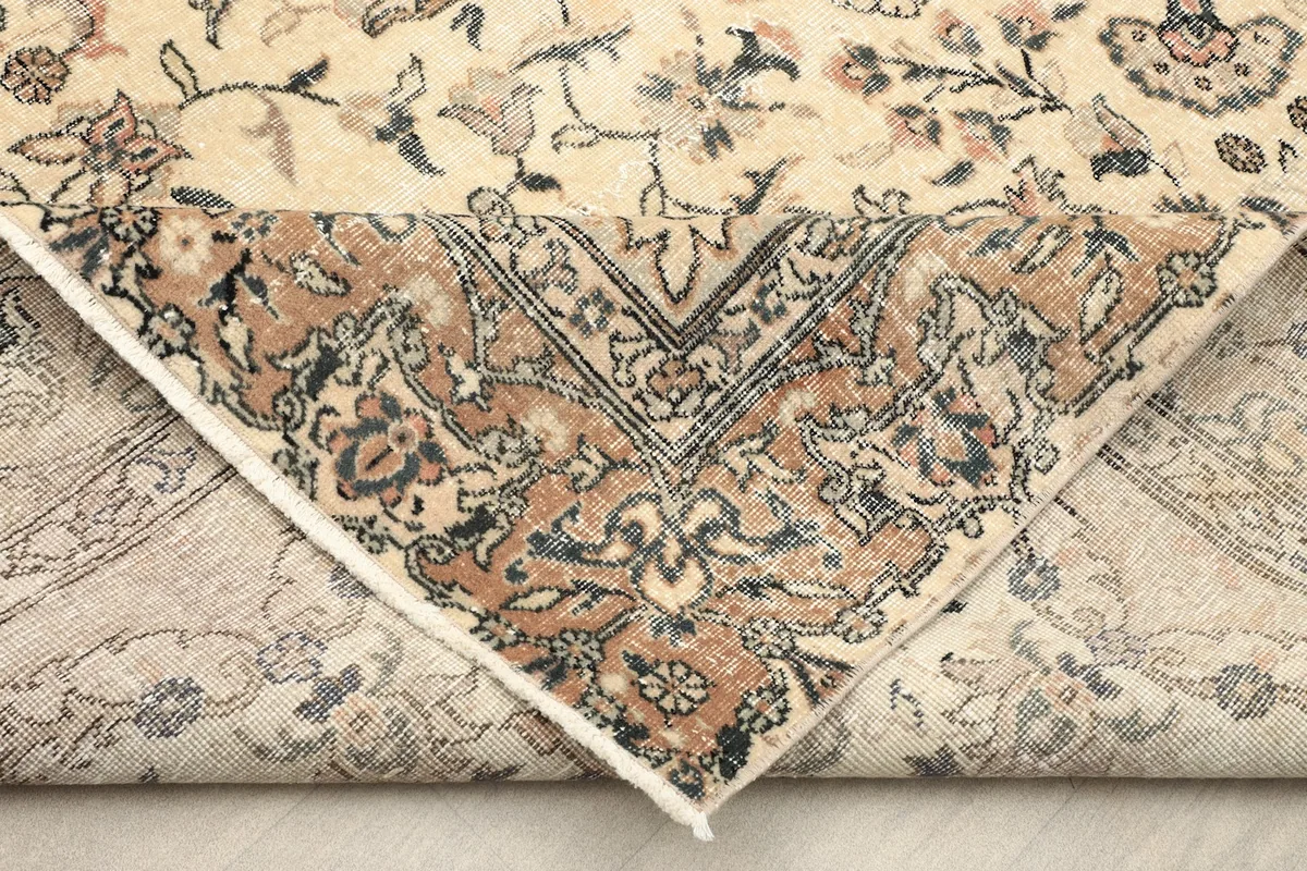 Underside of the rug revealing the hand-knotted cotton foundation and wool pile