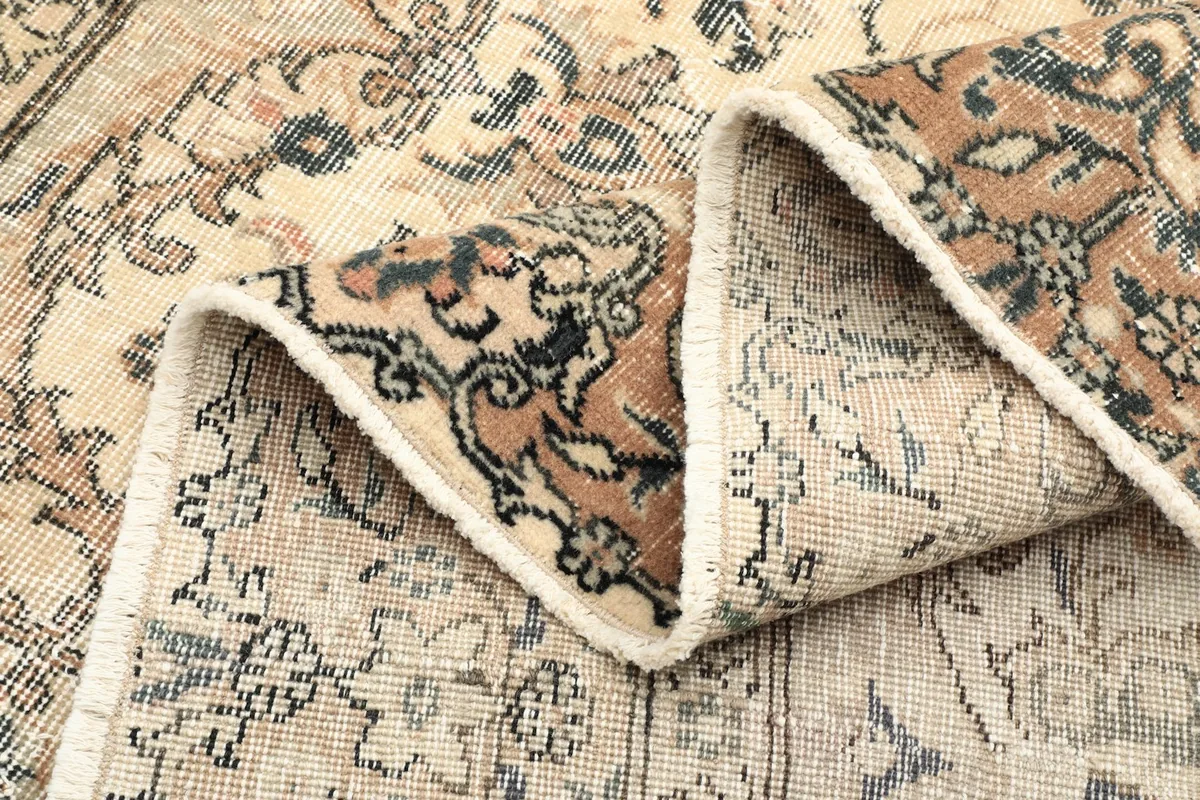 Folded section of the rug showing the thickness and texture of the wool pile