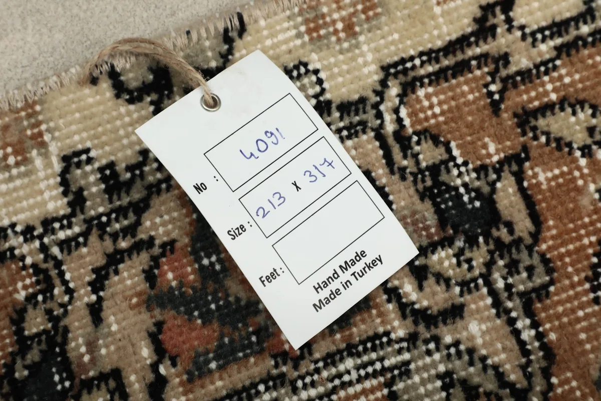 Product tag on the rug showing details like size and handmade origin