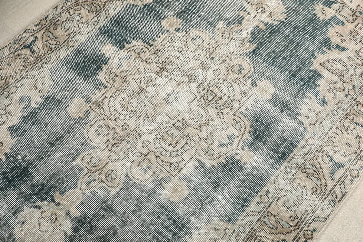 Central medallion of the Faded Gray Medallion Rug, showcasing intricate patterns and color variations.