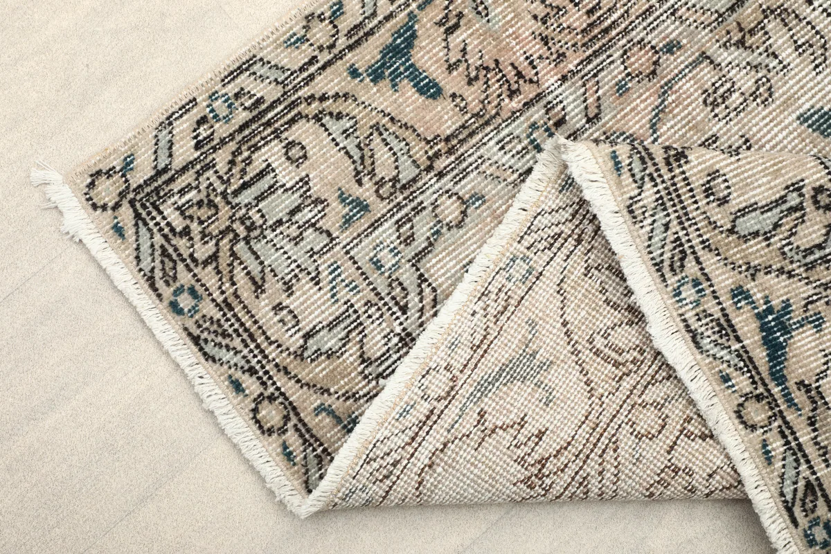 Faded Gray Medallion Rug folded to show the thickness and flexibility of the material.