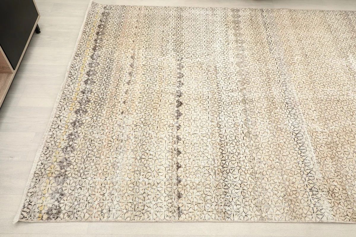 Detail of the rug's patterns and natural patina from a corner angle