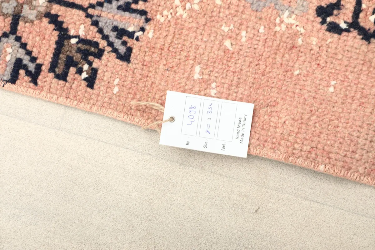 Close-up of the product tag attached to the rug, displaying its dimensions and origin.