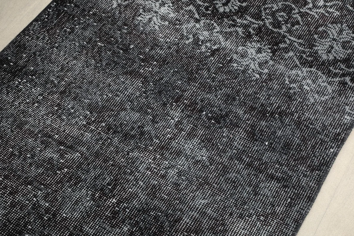 Close-up of the low wool pile, showing individual fibers and the distressed appearance