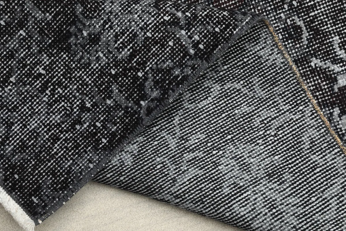 View of the rug's back and pile side by side, illustrating the hand-knotted construction