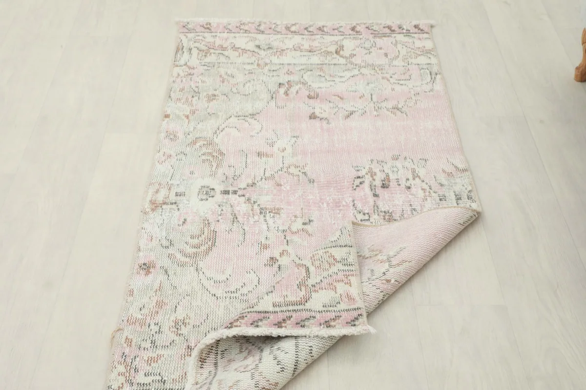The rug partially folded, illustrating its flexibility and the overall design from a different perspective