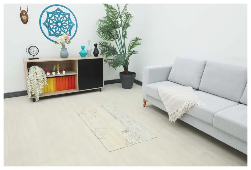 Full top view of the ivory and beige vintage Anatolian rug on a white background