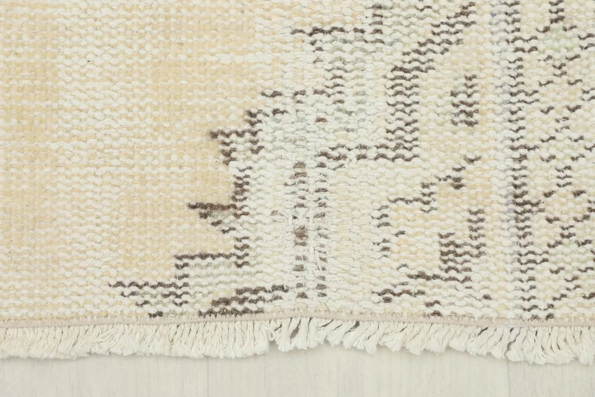 Close-up of a section of the rug, revealing the intricate, worn tribal design