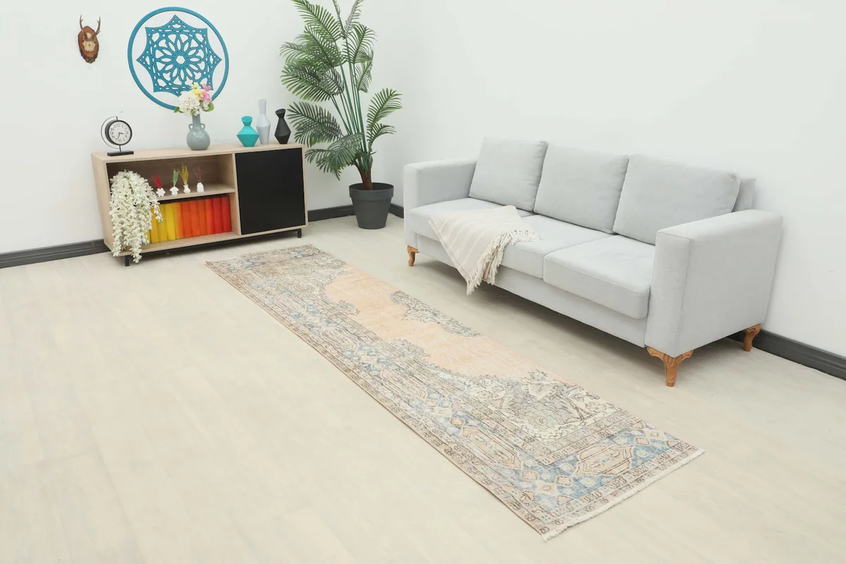 Runner rug displayed in a modern living space, showing its length next to a light gray sofa