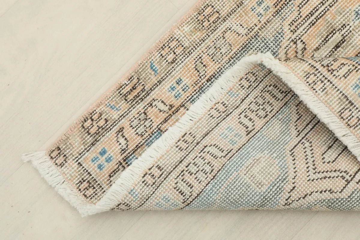 Detailed view of the back of the rug, showing the hand-knotted wool pile on cotton foundation