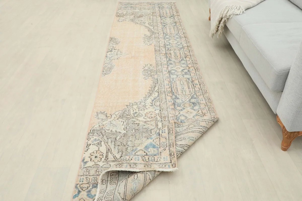 Runner rug partially folded, showcasing its flexibility and the overall design in a room setting.