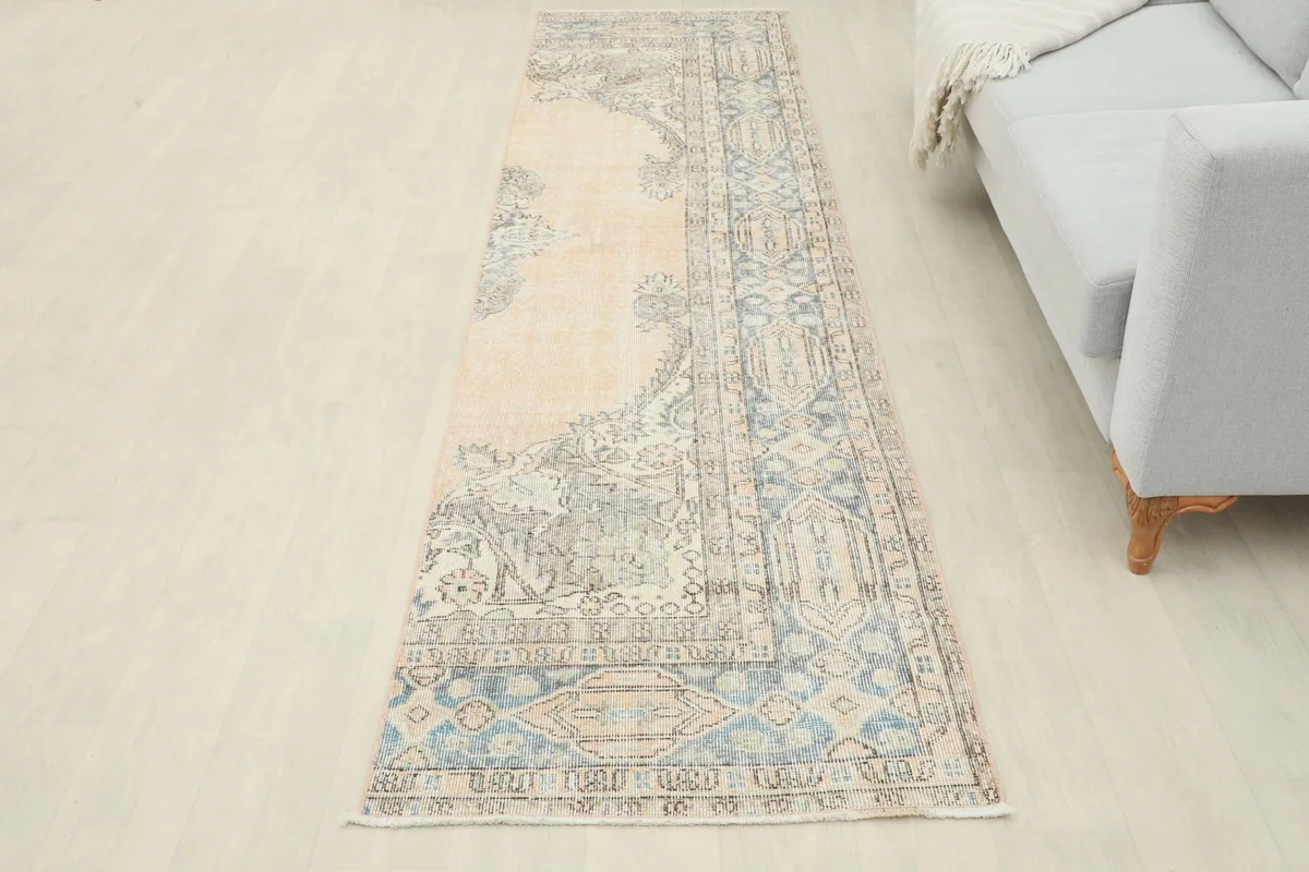 Full overhead view of the runner rug placed in a living room, showing its length relative to the sofa.
