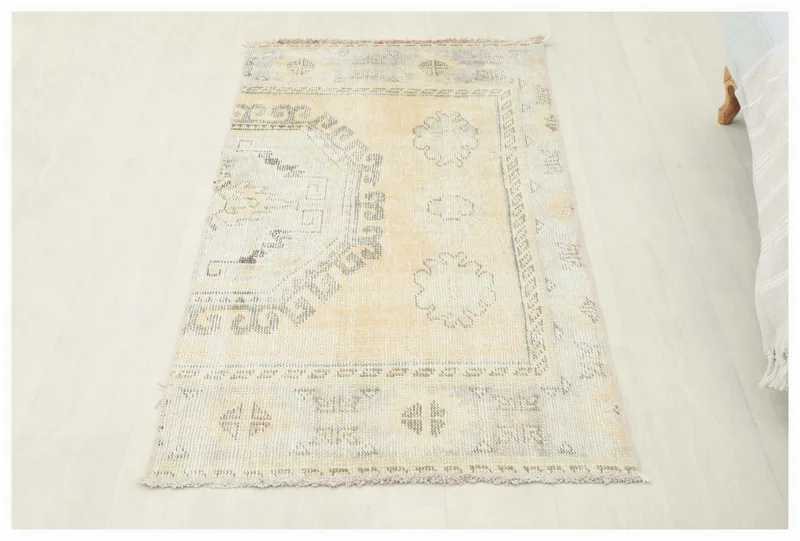 Full overhead view of the beige and ivory vintage Anatolian rug on a white background