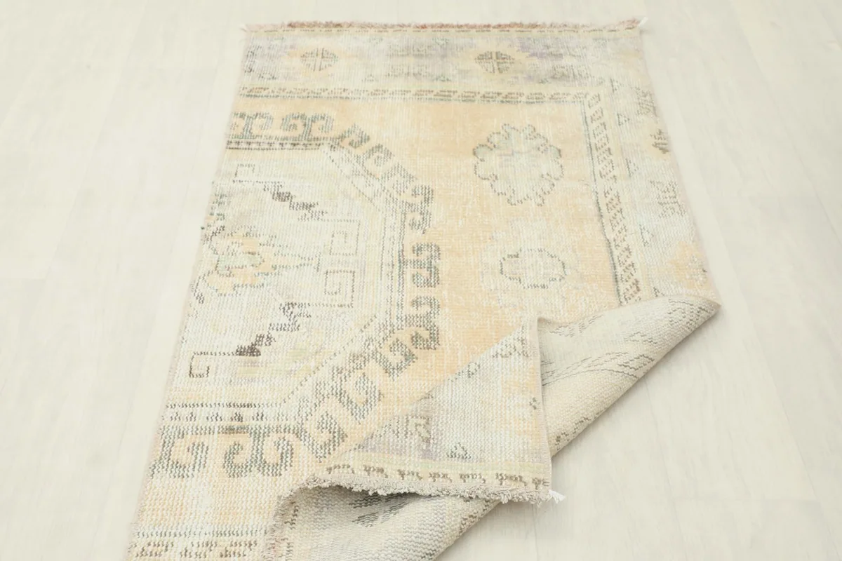 Rug folded to show the thickness and flexibility, displaying both front and back textures