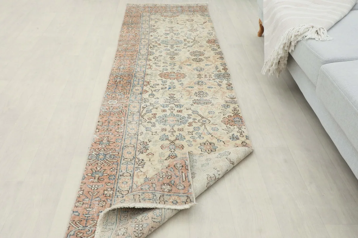 Runner partially unrolled in a room setting, showing its length and texture