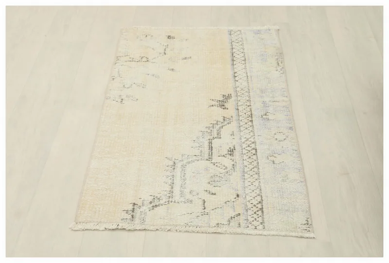 Full overhead view of the 2x4 cream and gray vintage Anatolian rug on a white background