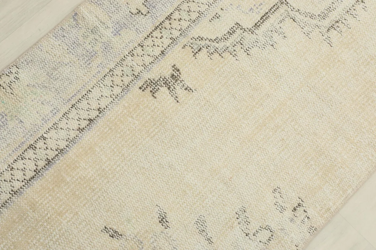 Detailed view of the central tribal patterns and border elements in gray and blue tones