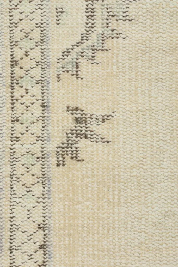 Very close view of the low wool pile and the intricate hand-knotted gray tribal designs