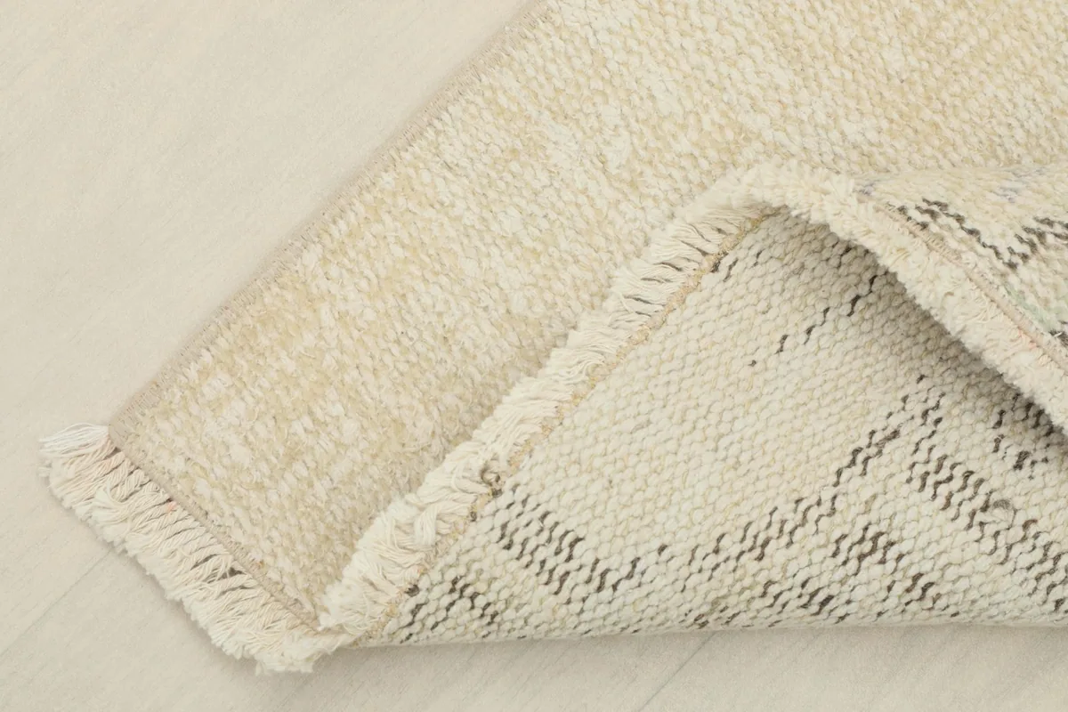 View of the back of the hand-knotted rug, showing the cotton foundation and knotting