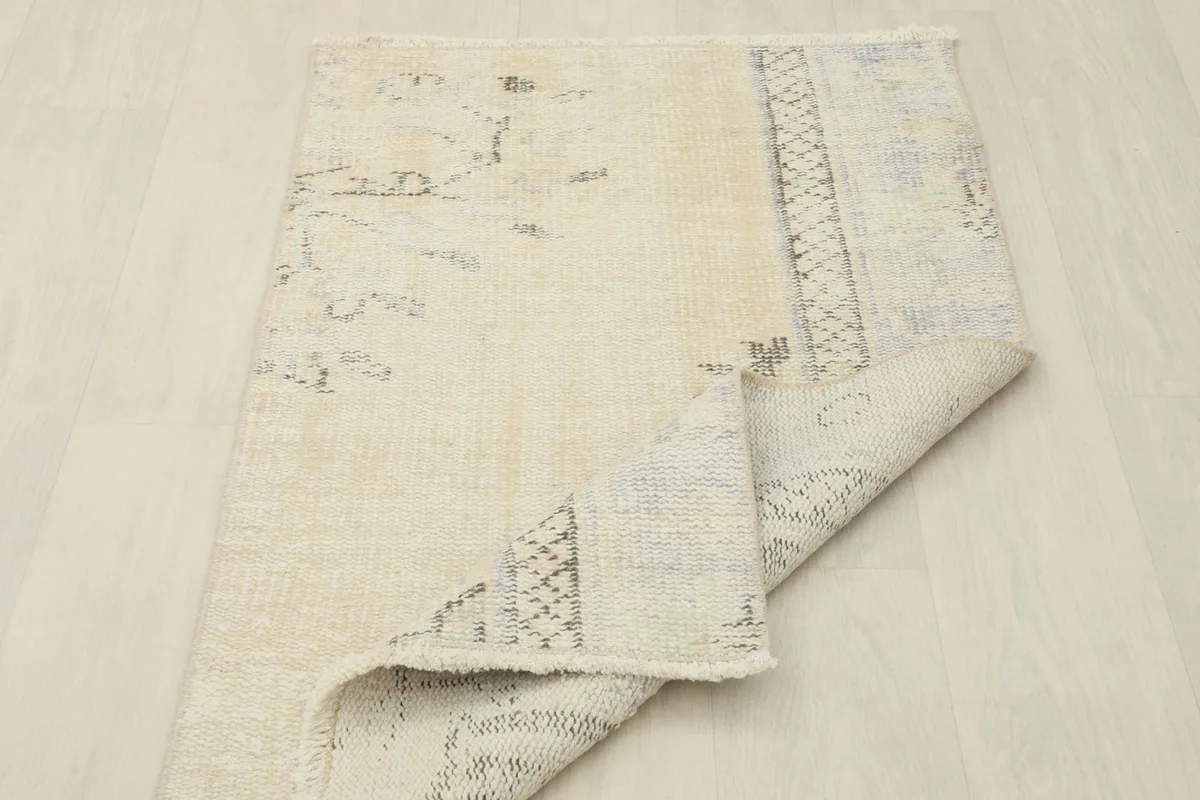 The rug folded to show its flexibility and the texture of the wool pile and cotton foundation