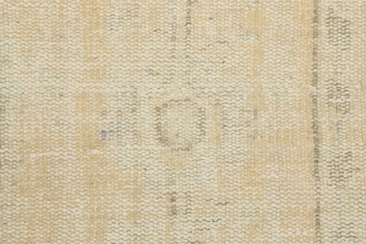 Close-up of the low wool pile, showing the hand-knotted weave and subtle color shifts