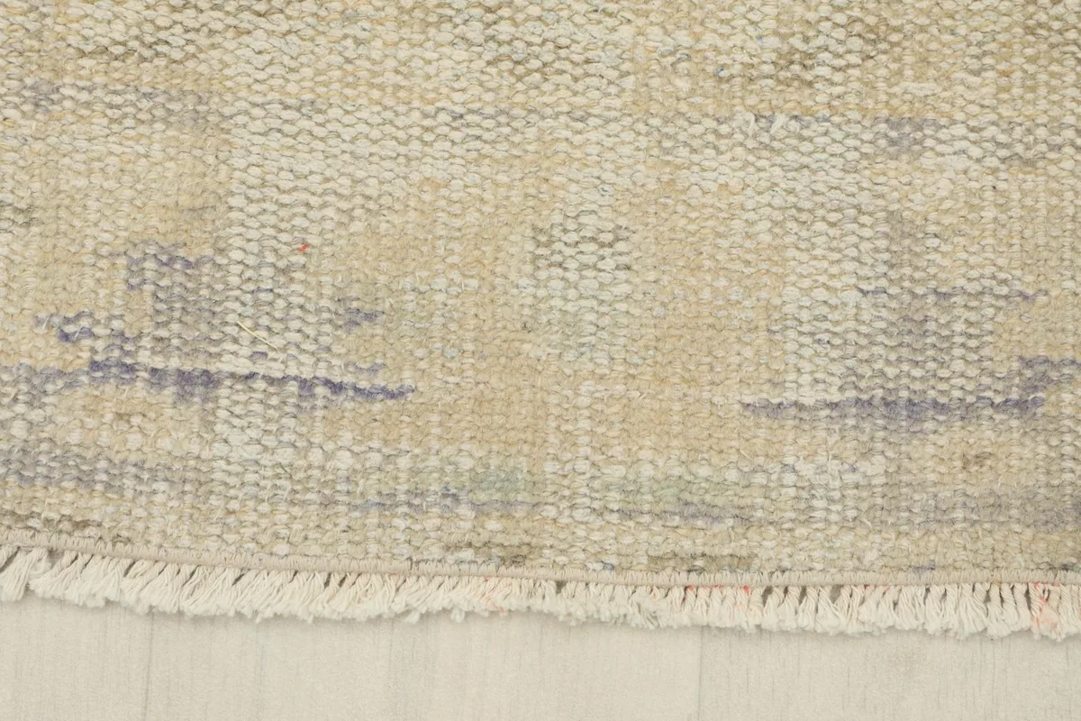 Detail of the short, natural fringe and worn edge of the vintage runner