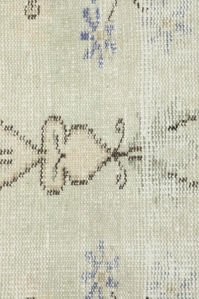 Very close view of the wool pile texture and the intricacy of the hand-knotted patterns.