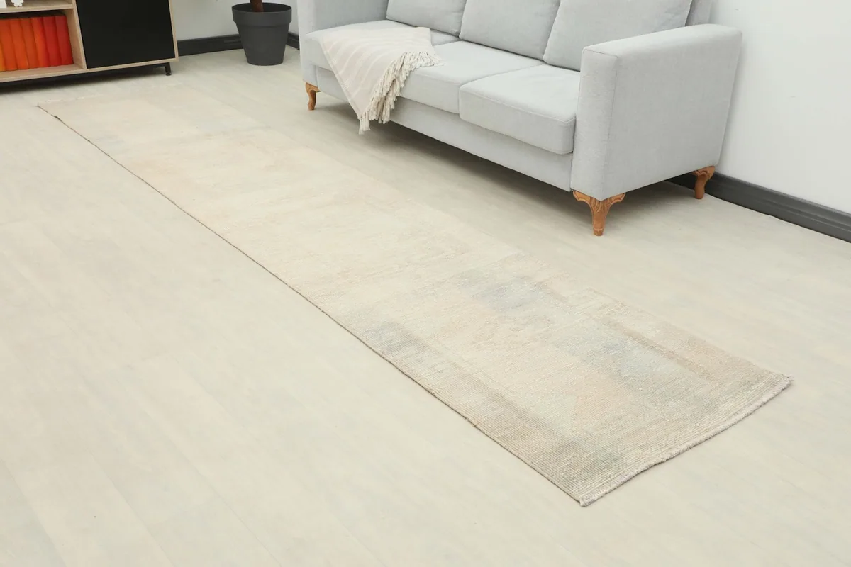 Angled view of the beige runner rug extending into a living space