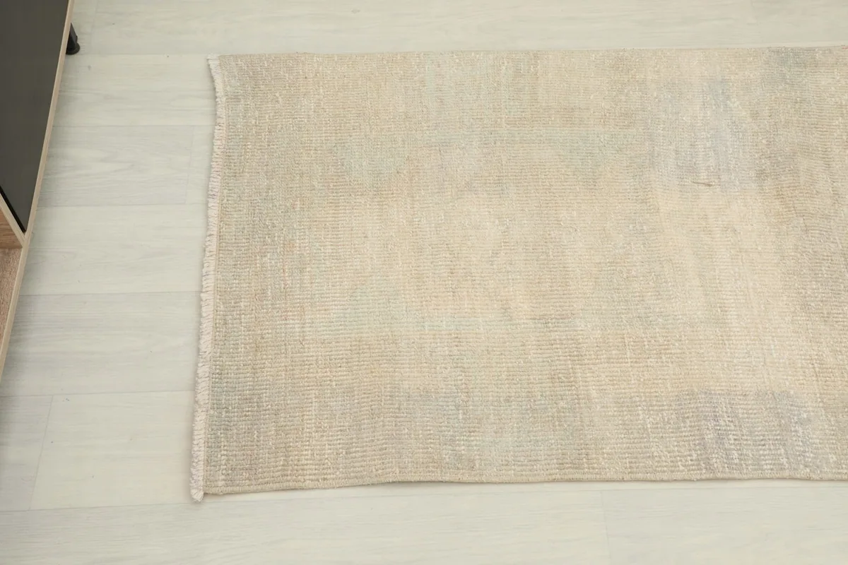 Close-up of the rug's mid-section, highlighting the overall beige color and texture