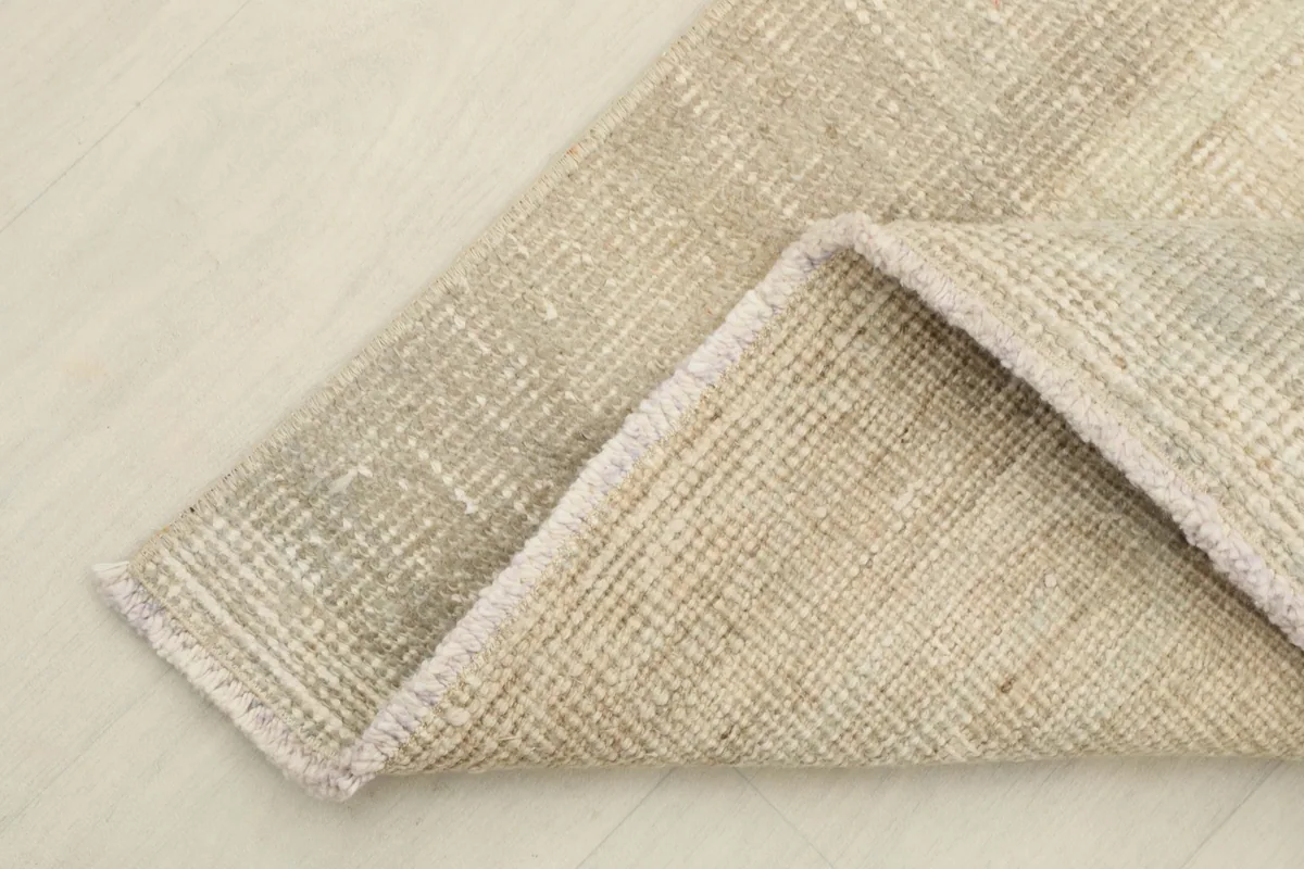 The rug folded to show the wool pile on the cotton foundation