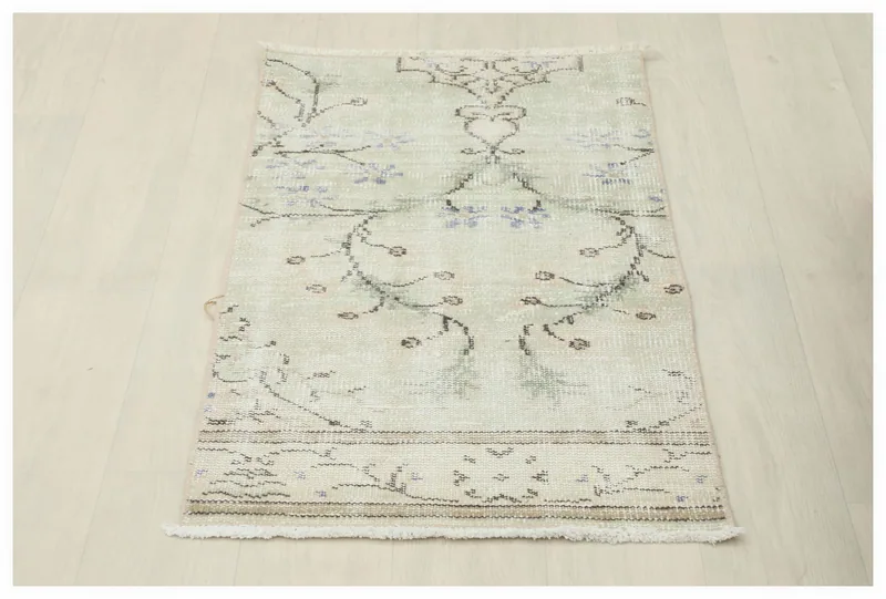 Full top view of the cream and blue floral vintage Anatolian area rug