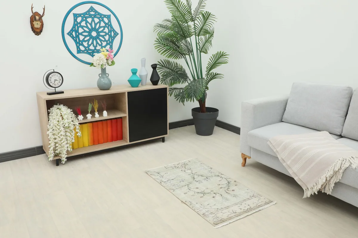 Vintage cream and blue floral rug placed in a living room setting
