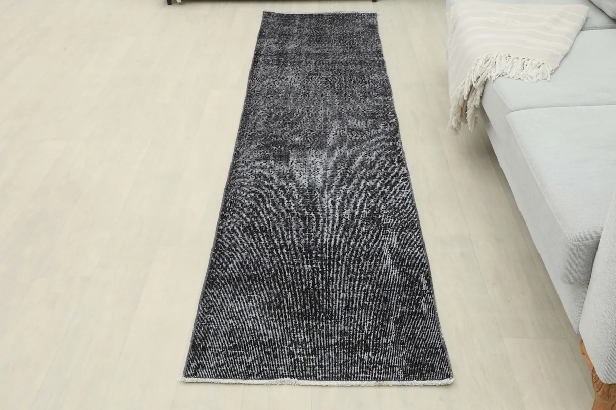Overhead view of the charcoal runner rug laid out in a room, providing a sense of its size and scale.