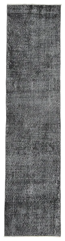 Full overhead view of the charcoal distressed geometric runner rug on a white background