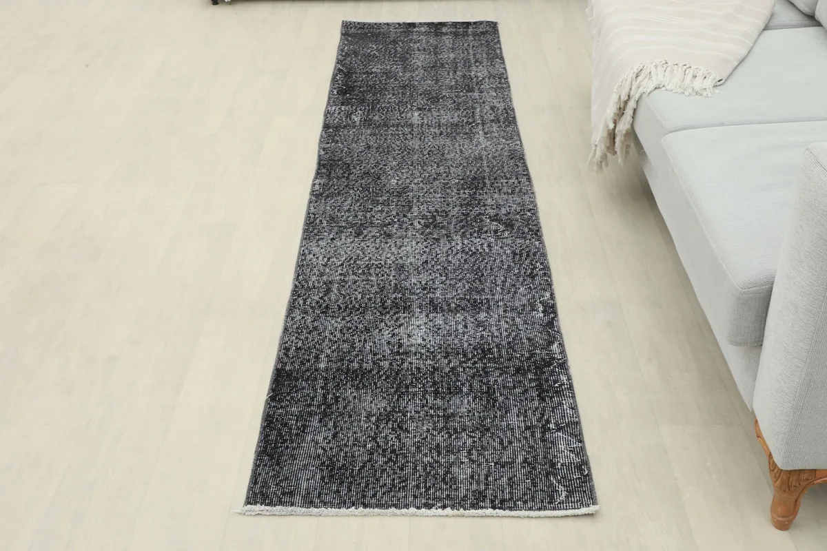 Full view of the charcoal runner rug in a room, offering a sense of scale and placement