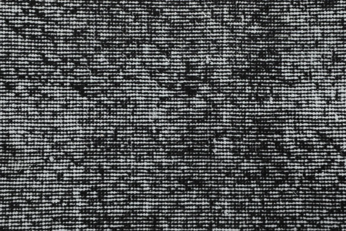 Macro view of the hand-knotted wool pile, showing individual knots and color blend