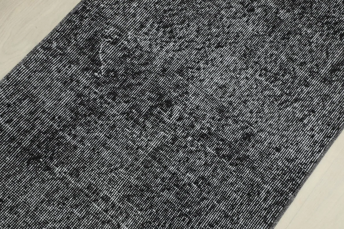 Close-up of the low pile and texture of the charcoal wool rug