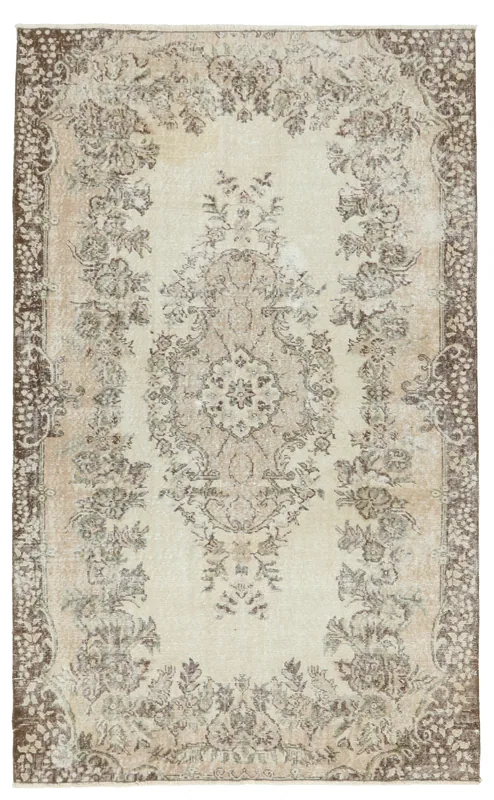 Full overhead view of the vintage ivory tan floral medallion rug on a white background.