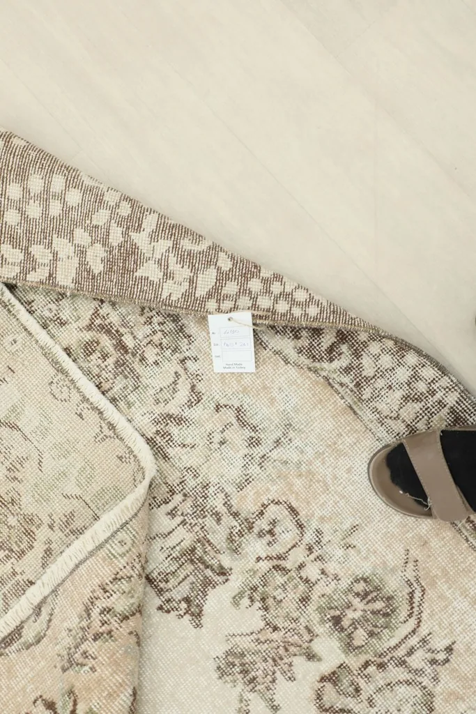 Overhead view of the rug's back, displaying the intricate knotting and the woven label.