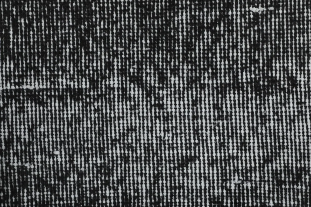 Extreme close-up showing the tightly knotted wool pile and subtle pattern