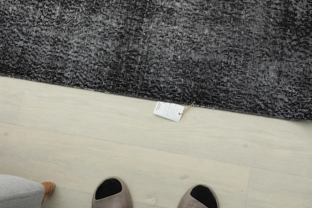 Overhead view of the rug with a small tag visible on the floor next to it
