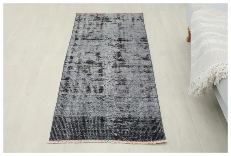 Full top view of the 2'2" x 5'3" charcoal and gray distressed vintage runner rug on a white background.