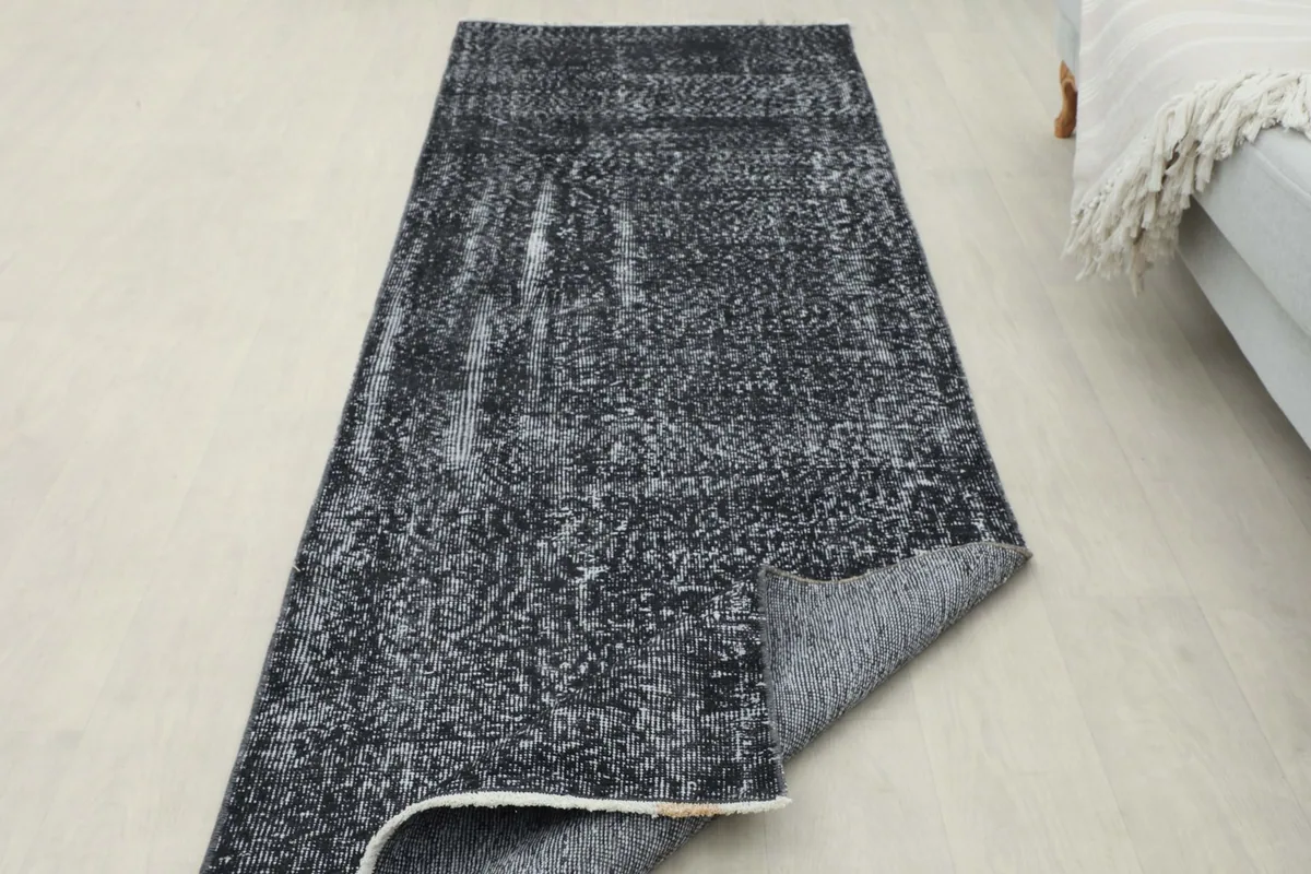 The runner partially folded to display its thickness and the texture of the reverse side.